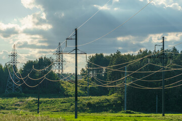 Power lines running through the forest. The support of an overhead power line. Natural landscape and technological progress.