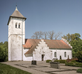 whitewashed Scandinavian church with towers reaching for the blue sky
