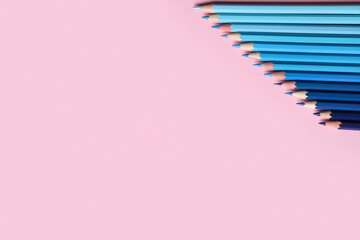 Blue pencils on pink background
