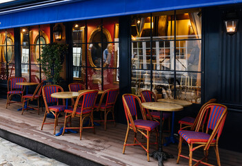 Cozy street with tables of cafe  in Paris, France. Cityscape of Paris. Architecture and landmarks of Paris