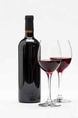 Wine Bottle And Glasses. Red Wine in Glass and Bottle on White Background. Still Life Concept with Copy Space