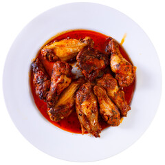Plate of tasty snack - roasted chicken wings. Isolated over white background