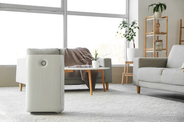 Modern humidifier and comfortable sofa in stylish living room