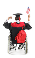 Female graduate in wheelchair with USA flag on white background, back view