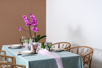 Beautiful table setting with orchid flower for wedding celebration in room