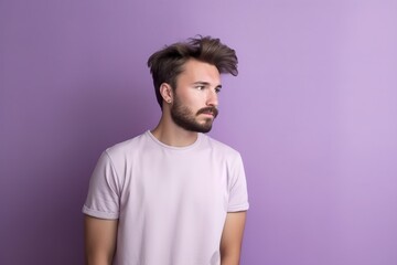 Fototapeta premium A man with a beard and a pink shirt is looking at the camera