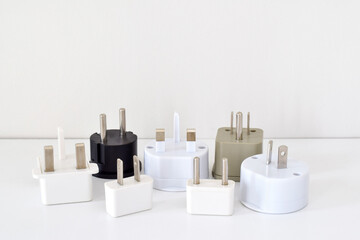 A group of travel power adapters on white background