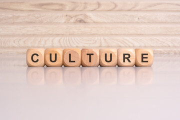 wooden blocks displaying the word 'CULTURE' arranged on a glossy gray surface