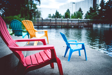 Colorful lawn chairs at the waterfront in a city park
