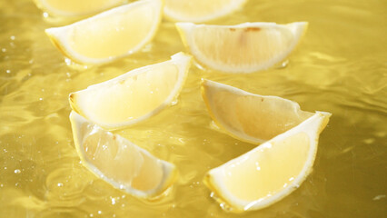 Macro of a fresh lemon slices arranged on yellow background. Close up of citrus fruit or lemon...