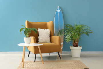 Interior of living room with surfboard, armchair and table