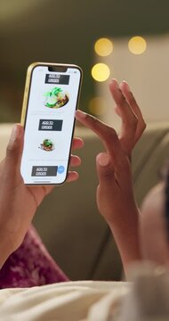 Hands, phone screen and food delivery app on sofa with scroll, thinking and choice for dinner in home. Person, smartphone and search for discount, sale and online shopping on mobil in apartment