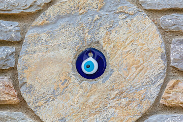 ?Evil eye wall decoration embedded in rustic stone surface for home protection and decor