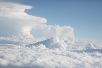 Sunrise above textured clouds from airplane window