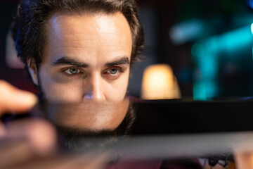 Close up shot of sleek tablet reviewed by influencer in home studio. Viral media star hosts technology internet show, analyzing digital portable device, feeling impressed by thinness