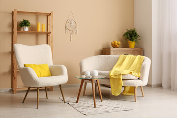 Interior of modern living room with white sofa, armchair, yellow plaid, coffee table and shelving unit