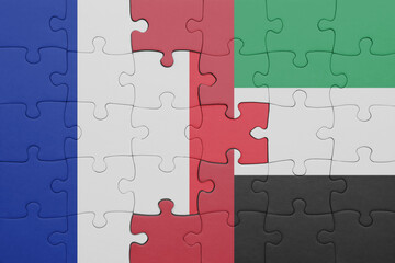 puzzle with the colourful national flag of united arab emirates and flag of france.