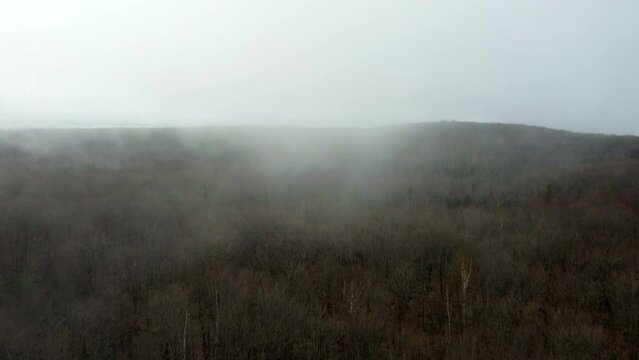 Miners Castle Road off of Highway 58 from R5 drone shot flying over the fog 
