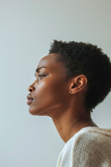 Obraz premium Detailed portrait of womans face against white wall, focusing on nose, cheek, eyelash, and jaw