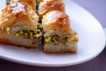  Local Turkish baklava on a white plate in a 360 degree rotating display case