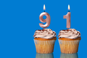 Birthday Cupcakes With Candles Lit Forming The Number 91.