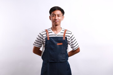 Portrait of asian handsome chef in blue apron standing isolated on white background