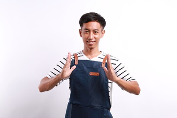 Asian man employer with blue apron holding something between hands isolated on white background
