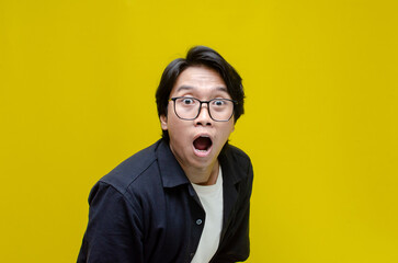 young asian man surprised with wow expression celebrating something. overjoyed  young asian man...