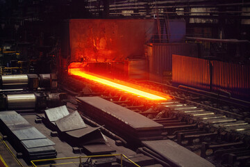 Rolled metal factory. Hot iron slab moving on conveyor of metal rolling mill © Mulderphoto