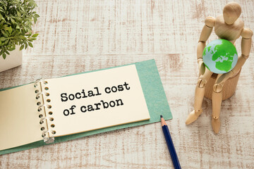 There is notebook with the word Social cost of carbon. It is as an eye-catching image.
