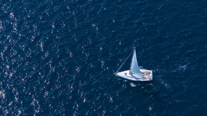AERIAL: Flying above a sailboat exploring the calm waters of the Adriatic sea.