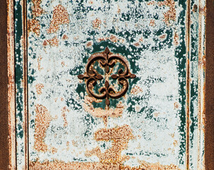 Old vintage door with ornament, details in blue and brown colors.
