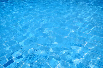 Rippled water in swimming pool background.
