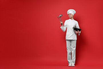 Professional chef with kitchen utensils on red background. Space for text