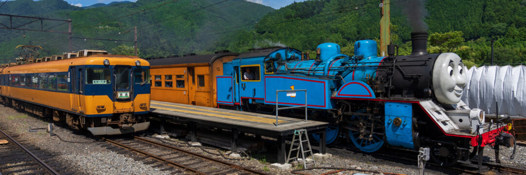 Shizuoka, Japan - April 10 2022: Oigawa railway train 16000 series local train and Thomas the tank engine train line up at Senzu station.