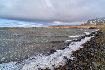 Beach ice on the shore pushed by waves