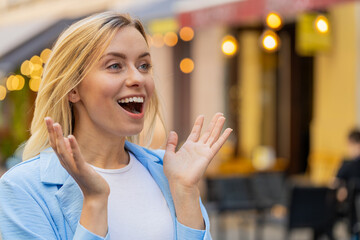 Oh my God, wow. Caucasian young woman looking surprised at side with big open eyes shocked by...