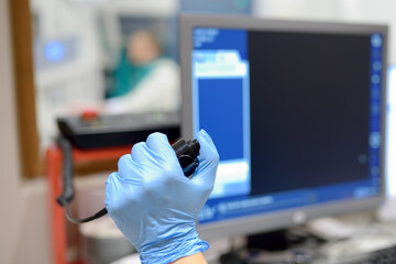 Radiologist is going to take X ray of patient in X-ray room of modern clinic. Close up photo of doctor hand presses button for execute of medical examination