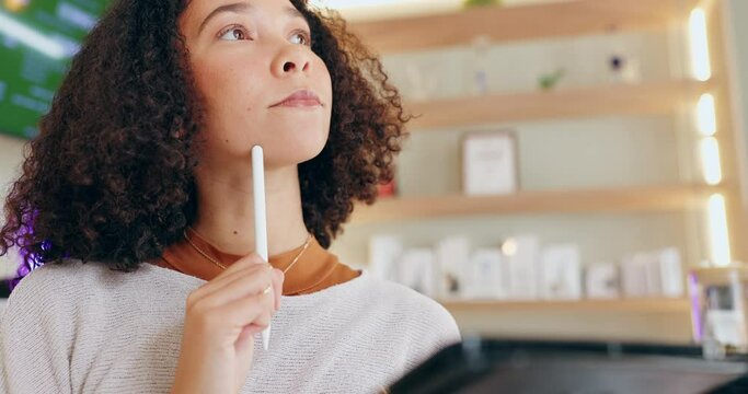 Black woman, thinking and writing on tablet in shop for inventory or stock control of cannabis edibles, sweets and retail. Girl, thoughts and digital technology for tracking or recording products.
