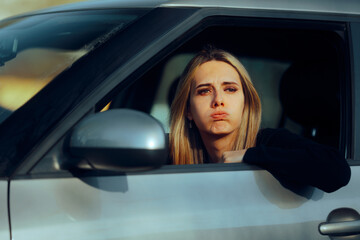 Unhappy Driver Looking out the Window at Traffic Jams. Angry woman sitting in rush hour in her automobile 
