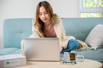 Business female sick she taking pills for flu while work with laptop keyboard, Asian sick woman...