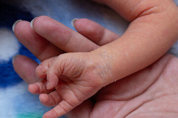 baby hand and mother hand holding each other