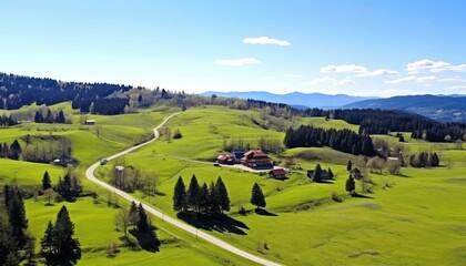 Obraz premium Stunning spring views of the countryside and green grass and beautiful flowers, with rolling hills and fertile soil, against a backdrop of vast mountains