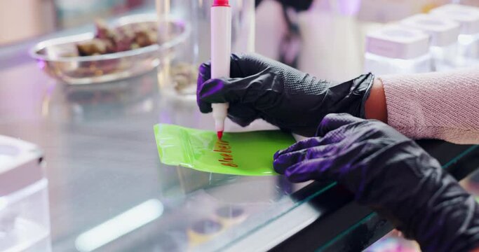 Hands, marijuana and person writing note in shop for cannabis, 420 and organic cbd dispensary. Weed, medical and drugs in store for thc, herb and retail label for natural plant in small business