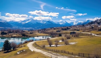 Stunning spring views of the countryside and green grass and beautiful flowers, with rolling hills and fertile soil, against a backdrop of vast mountains