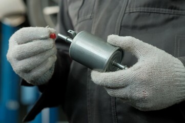 Auto parts.The fuel filter is new. Close-up.An auto mechanic prepares the fuel filter for...