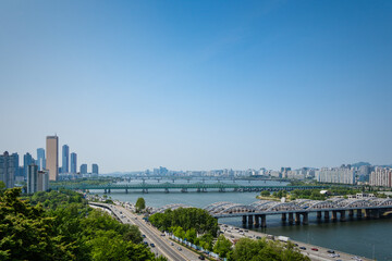 A view of Seoul with the Han River and several high-rise buildings