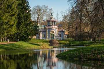 Chinese gazebo on the bank of the Upper Ponds in the Catherine Park in Tsarskoye Selo on a sunny spring day, Pushkin, St. Petersburg, Russia