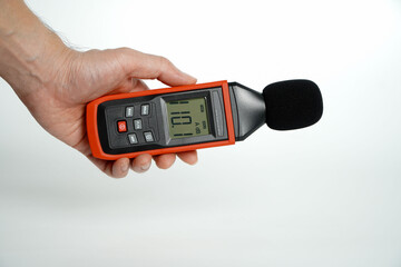 Pollution is too loud.hand holding a digital sound level on a white background,Sound level meters...