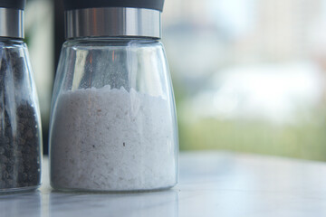 salt in a transparent jar on a table 